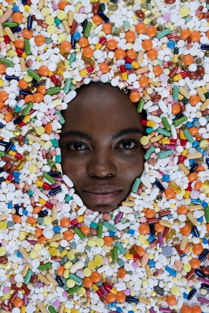A face surrounded by a vibrant mix of colorful pills, capturing the essence of modern medicine.